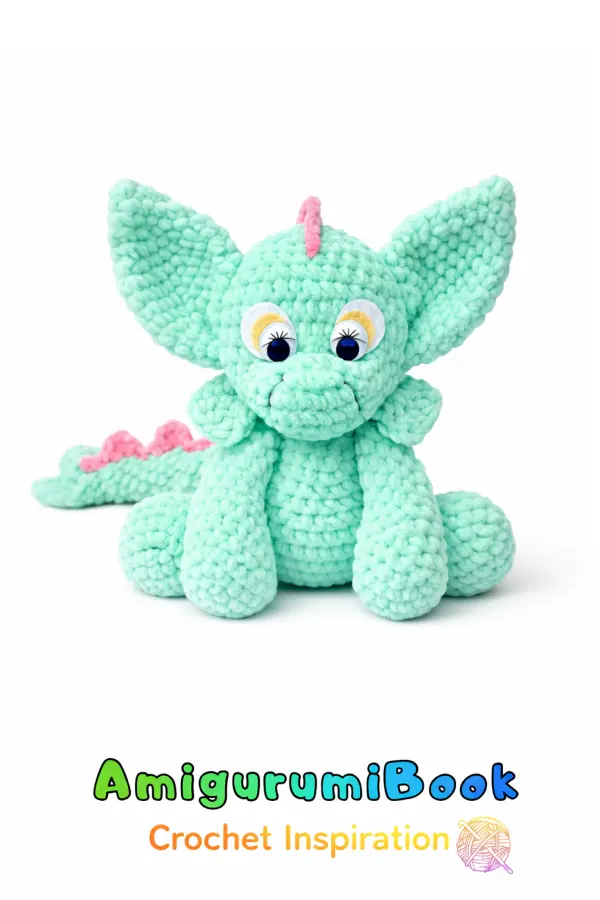 Cute dragon amigurumi crochet doll made with plush yarn, front view showing facial details